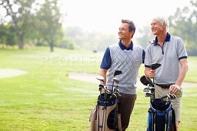 Buy stock photo Happy father and son on a golf course smiling and looking away