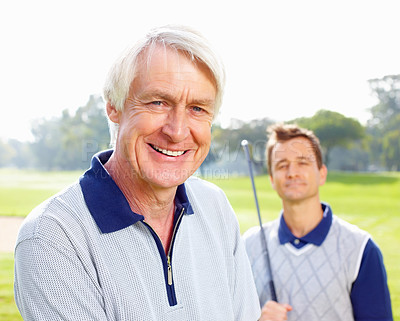 Buy stock photo Closeup of senior golfer smiling and looking at you with son in background