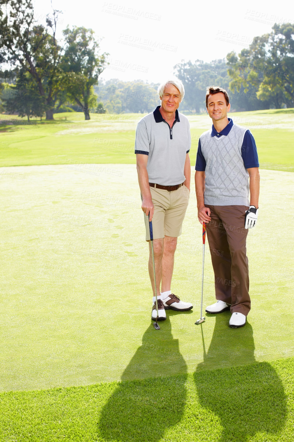 Buy stock photo Full length of father and son standing on golf course