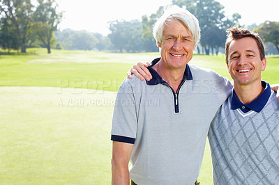 Buy stock photo Portrait of father and son on the golf course standing with arms around and smiling