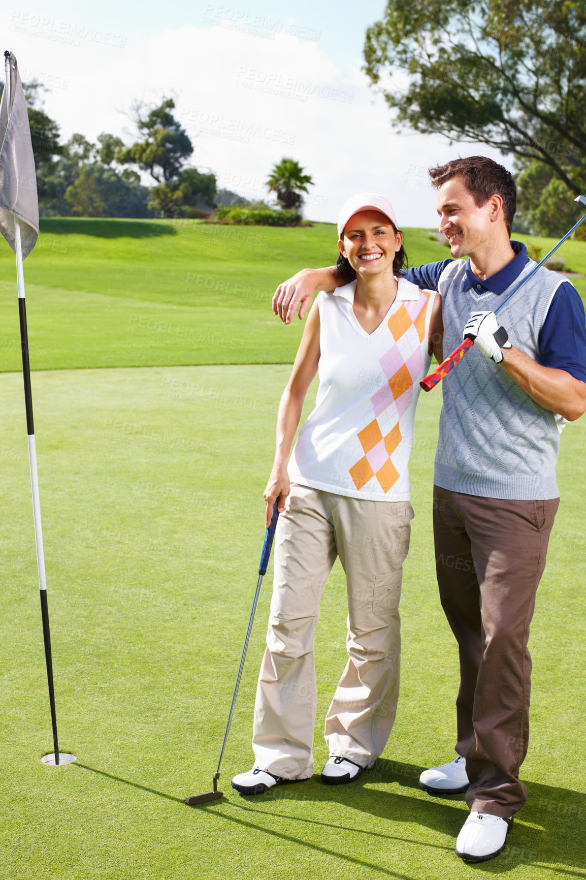 Buy stock photo Happy, portrait and couple on golf course with flag, outdoor fun and outdoor fitness on weekend morning. Love, woman and man at hole on green for sports date, health and wellness with partnership.