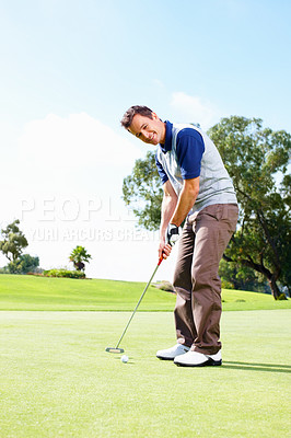 Buy stock photo Full length of smiling man playing golf and putting the ball