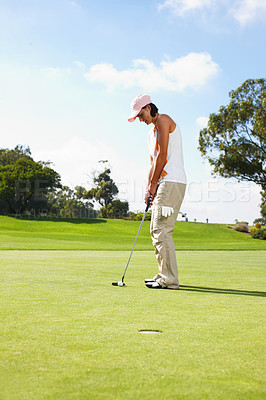 Buy stock photo Young woman putting on the golf course