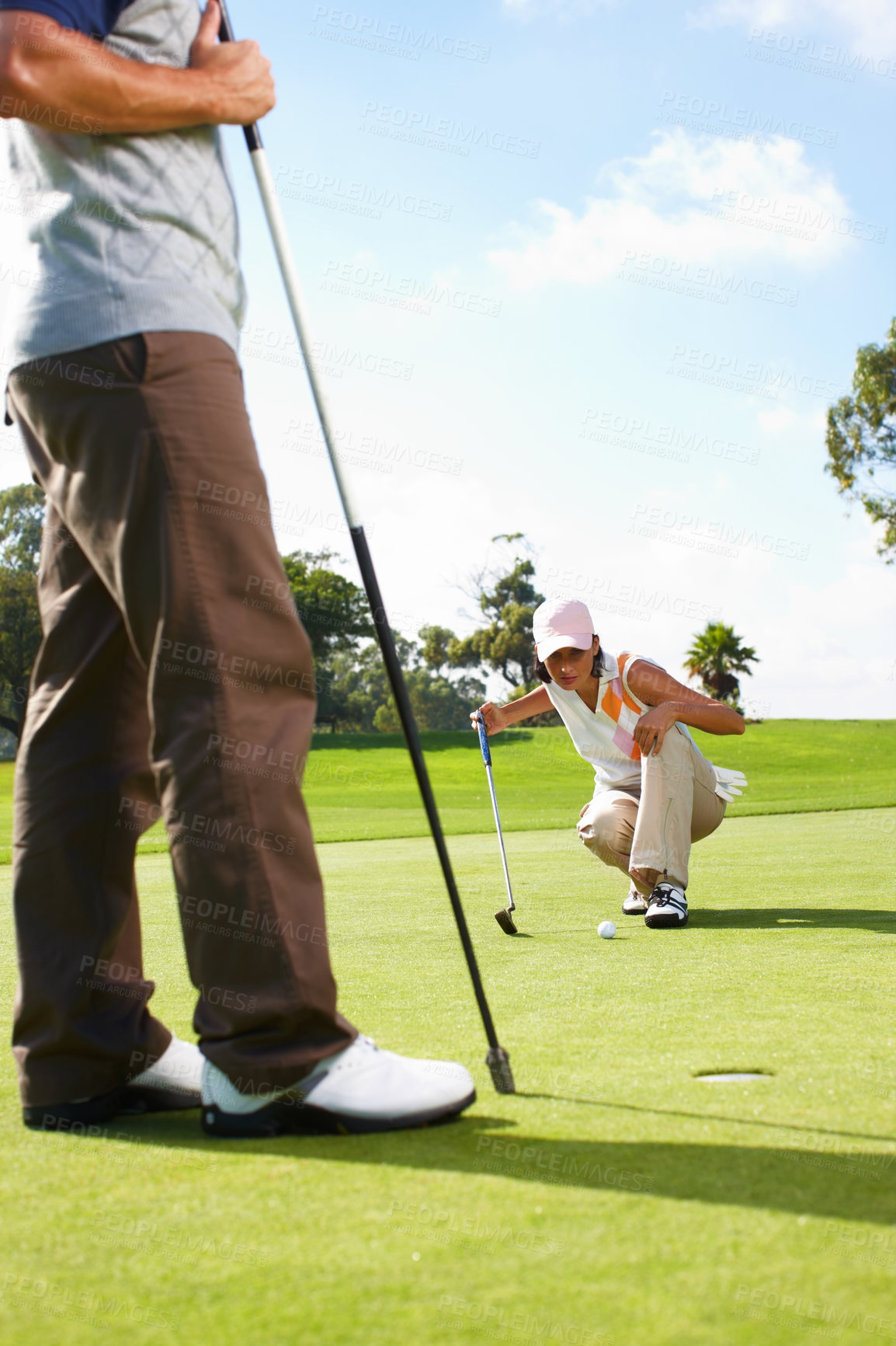 Buy stock photo Hole, woman and man on golf course with club for outdoor exercise, fitness and challenge on morning together. Sports, couple and golfer on green grass for competition, support and coaching in nature