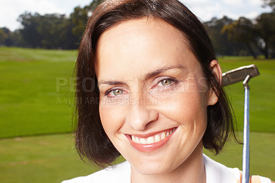 Buy stock photo Smiling mature woman holding her golf club while on the course - closeup