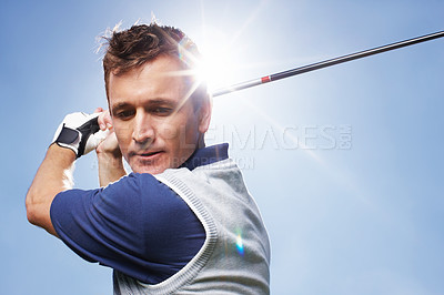 Buy stock photo Sports, golf club and man with swinging for game, training and practice for tournament match. Mockup, male person or serious golfer with skills for championship, coordination and playing by blue sky