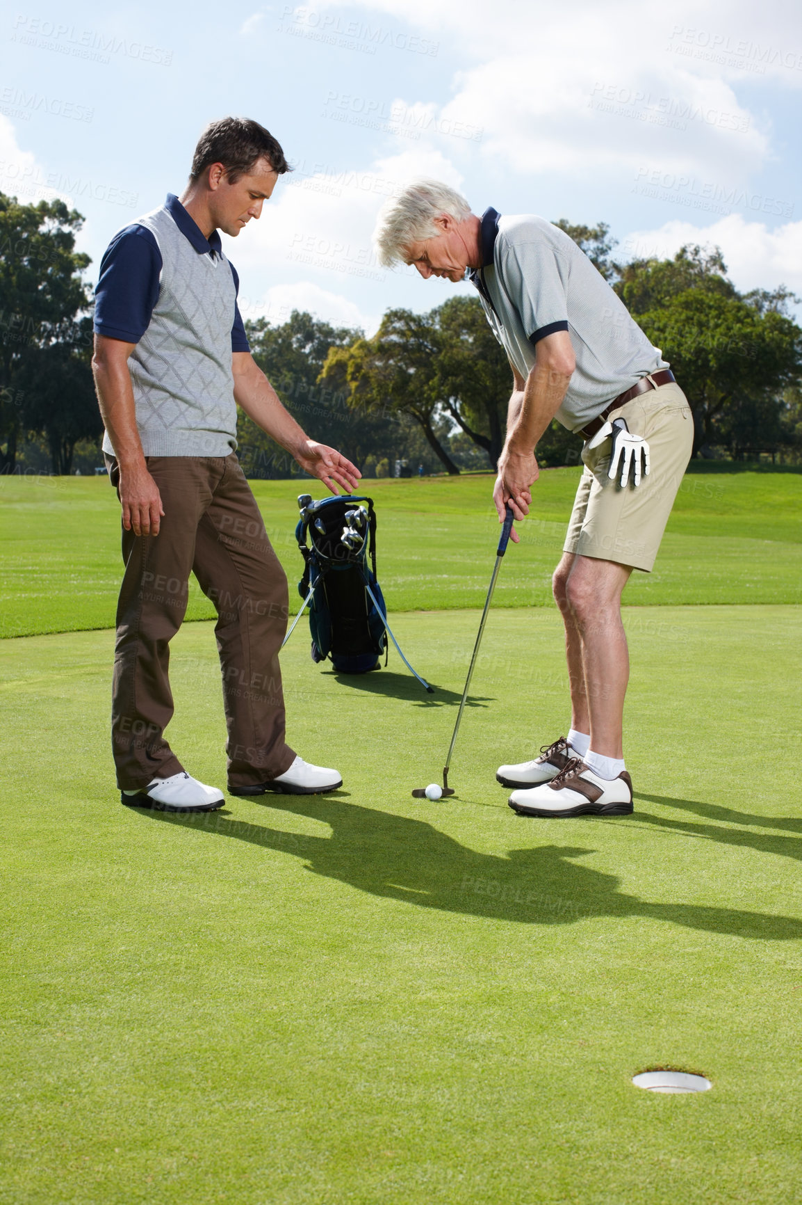 Buy stock photo Coaching, help and men on golf course together for teamwork, outdoor fun and fitness competition. Advice, senior father and son on green for teaching, learning and support in hobby at sports club