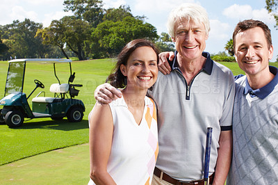 Buy stock photo Smiling golfing companions on the green with their golf cart in the background