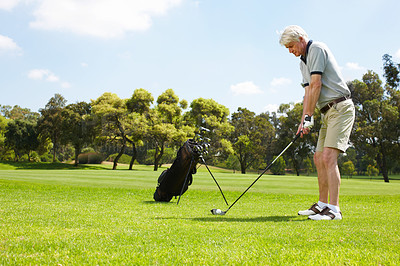 Buy stock photo Senior man getting ready to swing on the golf course