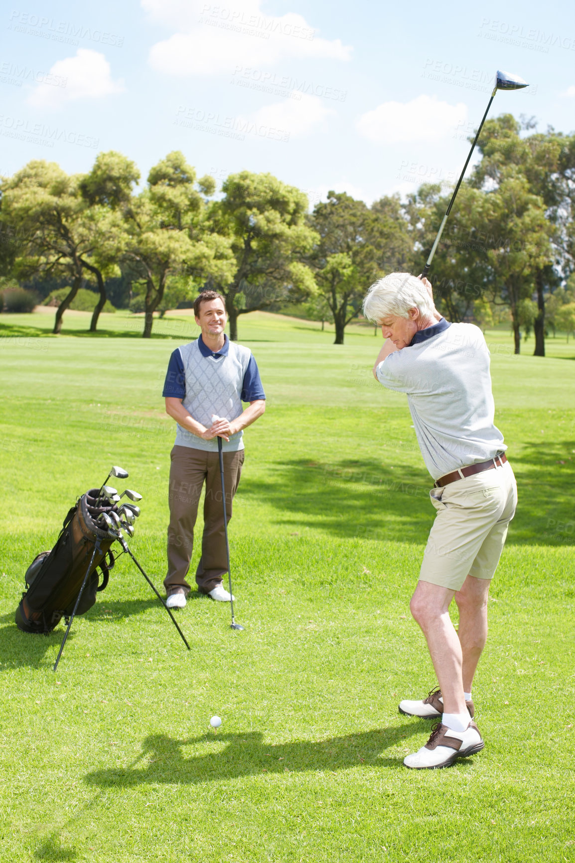 Buy stock photo Game, swing and men on golf course together for teamwork, outdoor fun and fitness competition in nature. Sports, senior father and son on green for partnership, bonding and support in club challenge