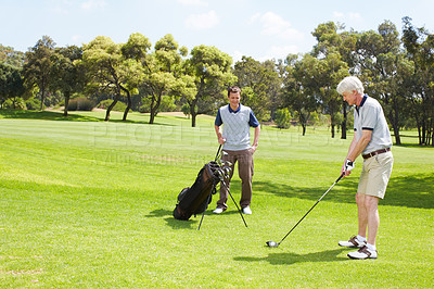 Buy stock photo Golfing companions out on the course playing a round of golf