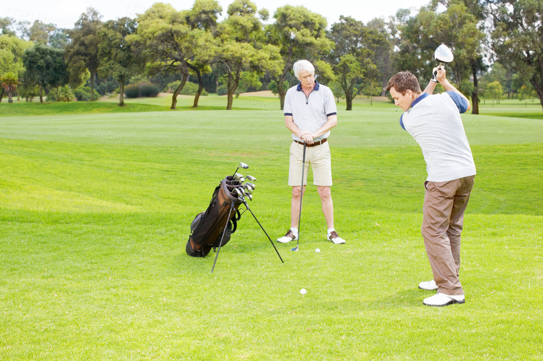 Buy stock photo Swing, play and men on golf course together for teamwork, outdoor fun and fitness competition in nature. Sports, senior father and son on green for partnership, bonding and support in club challenge