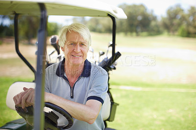 Buy stock photo Senior man sitting in his golf cart on the green