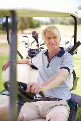 Buy stock photo Senior man sitting in his golf cart on the green