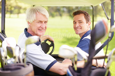 Buy stock photo Golfing companions on the golf course in a golf cart