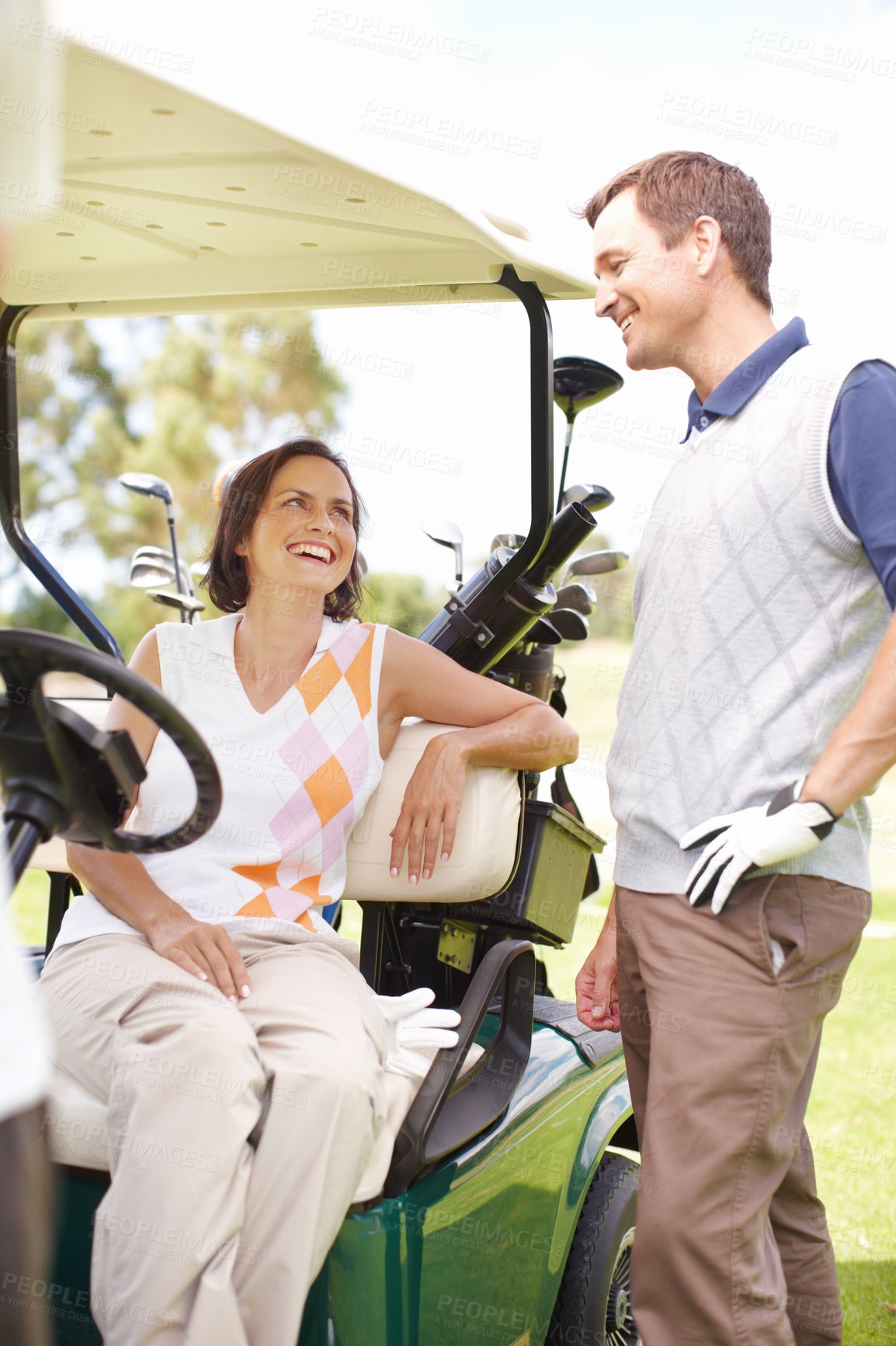 Buy stock photo Smile, club and happy couple in golf cart for game, outdoor bonding and fitness on weekend morning together. Love, woman and man in buggy for sports transport, health and wellness with fun exercise.