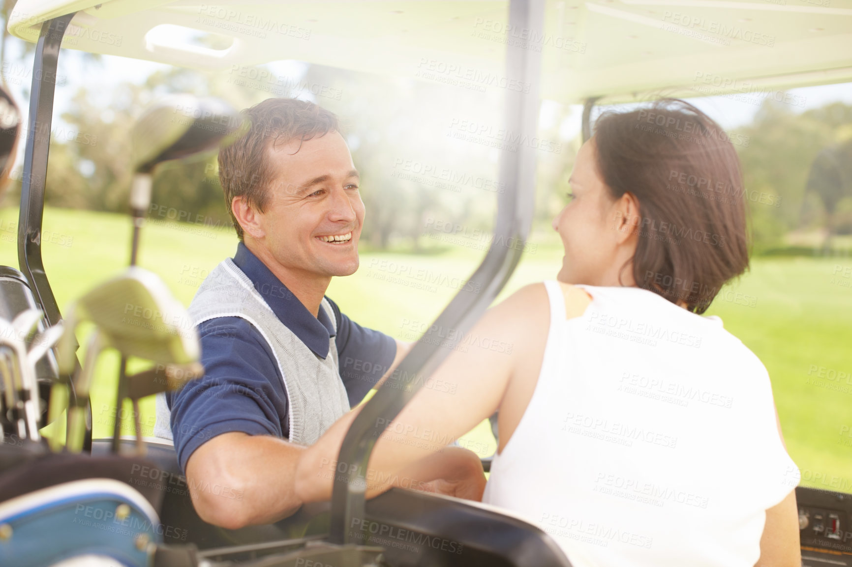 Buy stock photo Smile, course and couple in golf cart for game, outdoor bonding and fitness on weekend morning together. Love, happy woman and man in buggy for sports transport, health and wellness with fun exercise