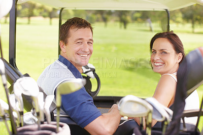 Buy stock photo Happy couple in a golf cart on the green