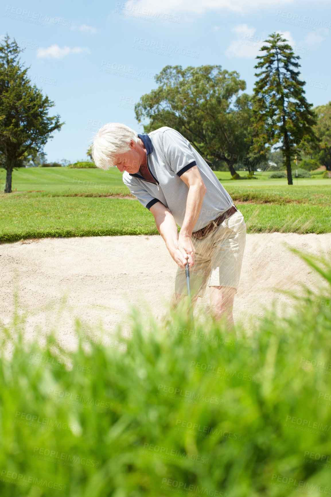 Buy stock photo Bunker, game and mature man on golf course with aim for outdoor exercise, fitness and challenge in morning. Sports, play and professional golfer in sand for swing, ball and competition in nature
