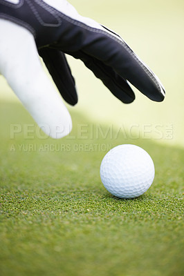Buy stock photo Cropped image of a golfer placing the ball ready to tee off on a golf course