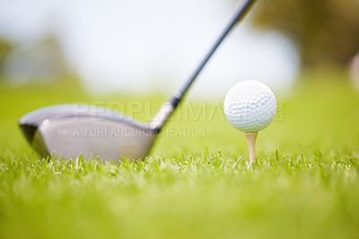 Buy stock photo Golf ball carefully balanced on a golf tee with a club in the background