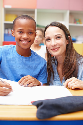 Buy stock photo School, classroom and portrait of teacher with child for help with quiz for learning, education and development. Academy, student and woman with boy for teaching, test and check answers in lesson