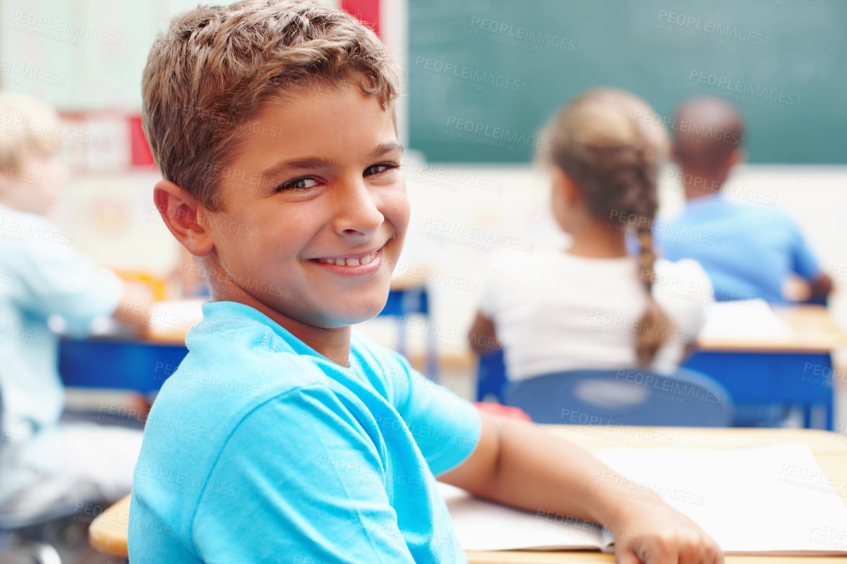 Buy stock photo Smile, portrait and boy at desk in classroom for learning, growth and child development in education. Happy, face and student in school for knowledge, study and future opportunity with scholarship.