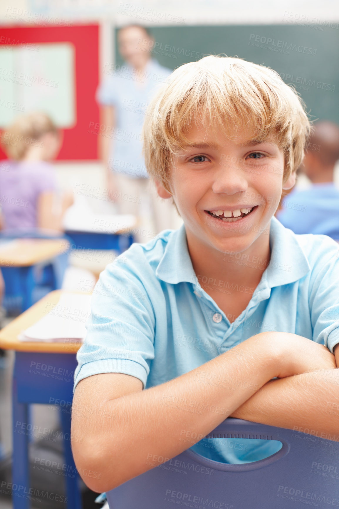 Buy stock photo Portrait of a cute blonde schoolboy in sitting at a desk in class