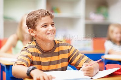 Buy stock photo Writing, happy and child in class with books for learning, education and lesson for development. Primary school, academy and boy with stationery for test, creativity and assignment for knowledge