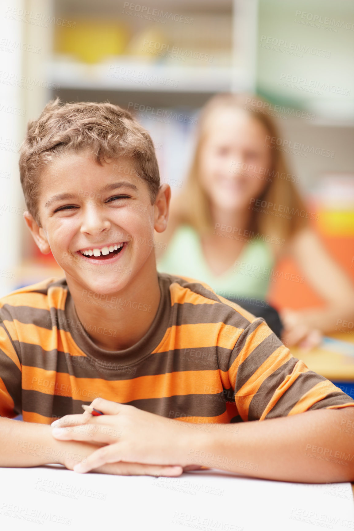 Buy stock photo Laugh, portrait and boy in kids classroom for learning, growth and child development at elementary school. Happy, face and student at desk for education, study and future opportunity for scholarship.