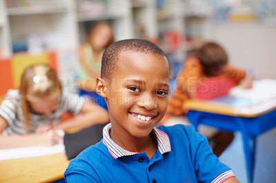 Buy stock photo Smile, portrait and boy in classroom for learning, growth and child development at elementary school. Happy, face and student at desk for kids education, study and future opportunity for scholarship.