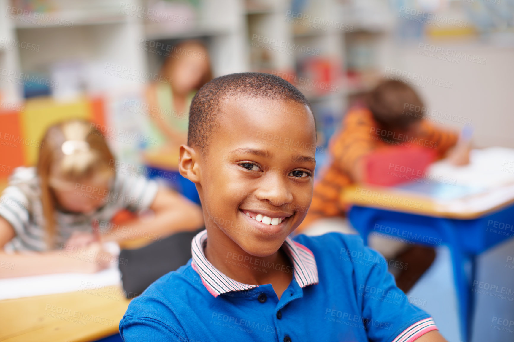 Buy stock photo Smile, portrait and boy in classroom for learning, growth and child development at elementary school. Happy, face and student at desk for kids education, study and future opportunity for scholarship.