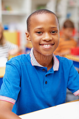 Buy stock photo Smile, portrait and boy in classroom for education, growth and child development at elementary school. Happy, face and student at desk for learning, study and future opportunity for scholarship.