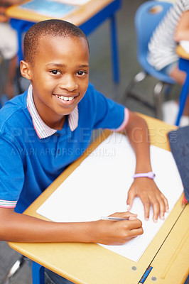 Buy stock photo School, books and portrait of child in classroom for learning, education and lesson for development. Happy, academy and young boy with pencil for assignment, creative writing and test for knowledge