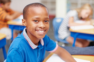 Buy stock photo Smile, portrait and kid in classroom for learning, growth and child development at elementary school. Happy, face and boy student at desk for education, study and future opportunity for scholarship.