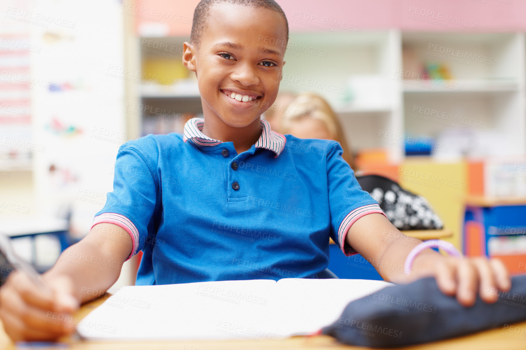 Buy stock photo Happy, books and portrait of boy in classroom for learning, education and lesson for development. Primary school, academy and student at desk for assessment, creative writing and test for knowledge