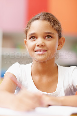 Buy stock photo Smile, thinking and girl in classroom for writing test, growth and child development at elementary school. Happy, face and student at desk for kids education, study and assessment for scholarship.