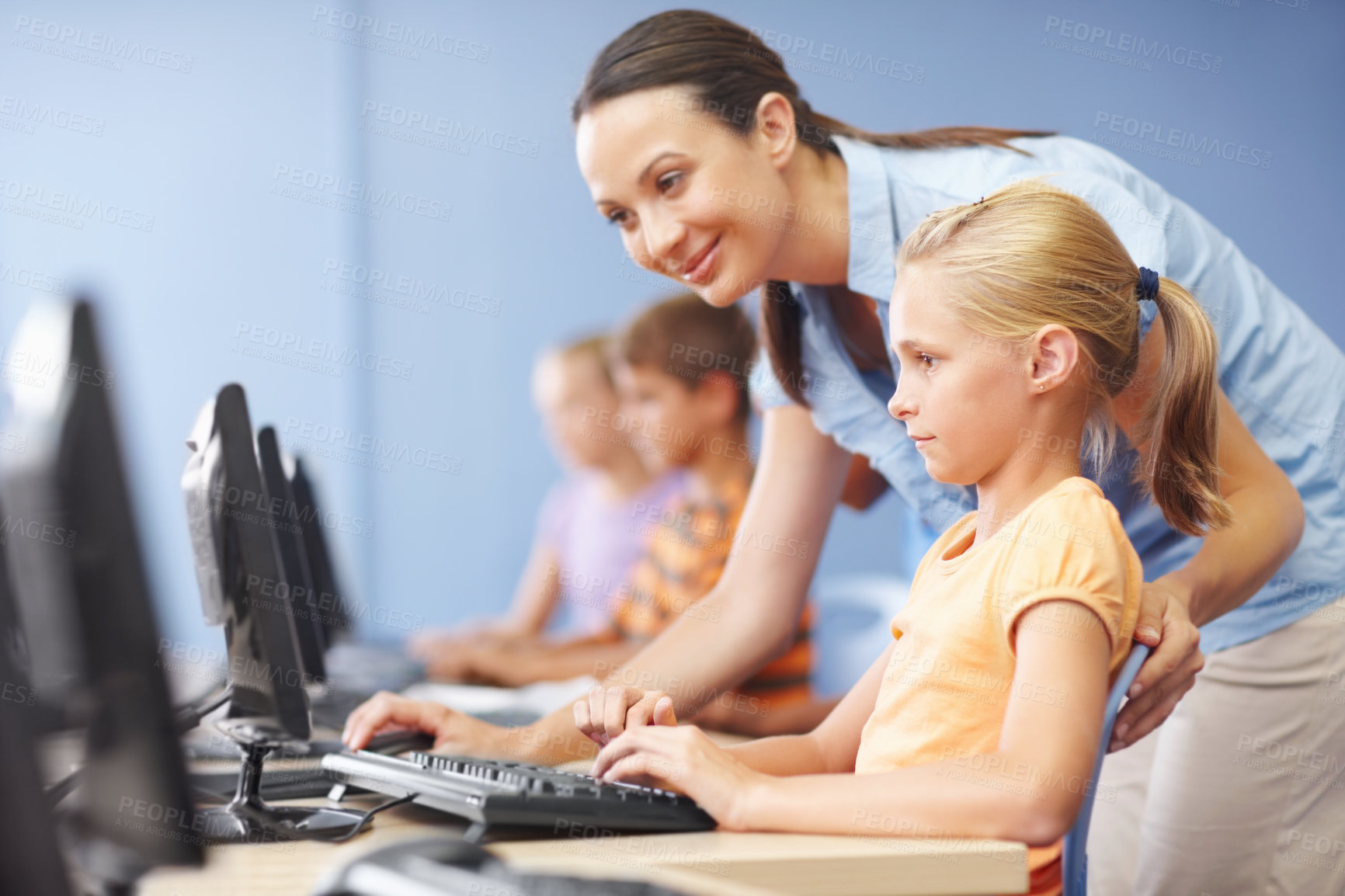 Buy stock photo Woman, teacher and smile with girl on computer in classroom for helping, teaching and learning. People, educator and happy online with student at elementary school for education and brain development