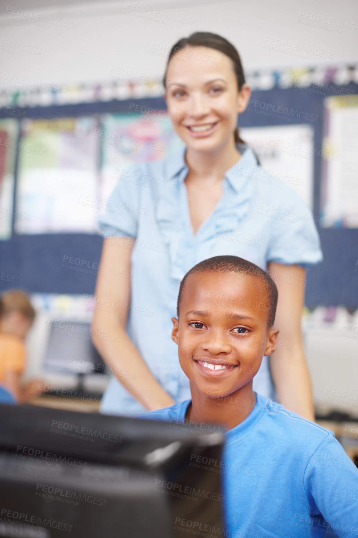 Buy stock photo Woman, teacher and happy on portrait with boy on computer in classroom for helping, teaching and learning. People, educator and proud with student at elementary school for education and development