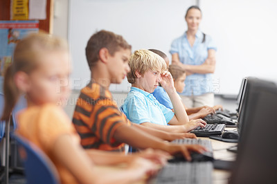 Buy stock photo A group of young kids working hard in computer class