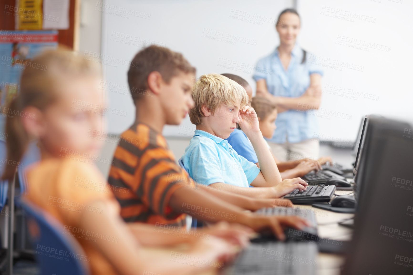 Buy stock photo A group of young kids working hard in computer class