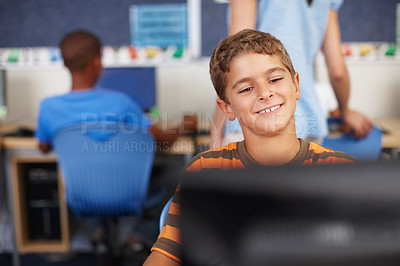 Buy stock photo A cute young schoolboy in computer class