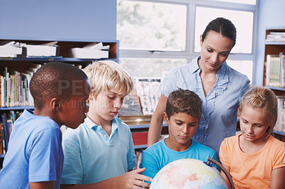 Buy stock photo Education, teacher and kids in classroom, globe and conversation with knowledge, talking and learning. Geography, woman and students in school, children or studying with answer, creative or world map