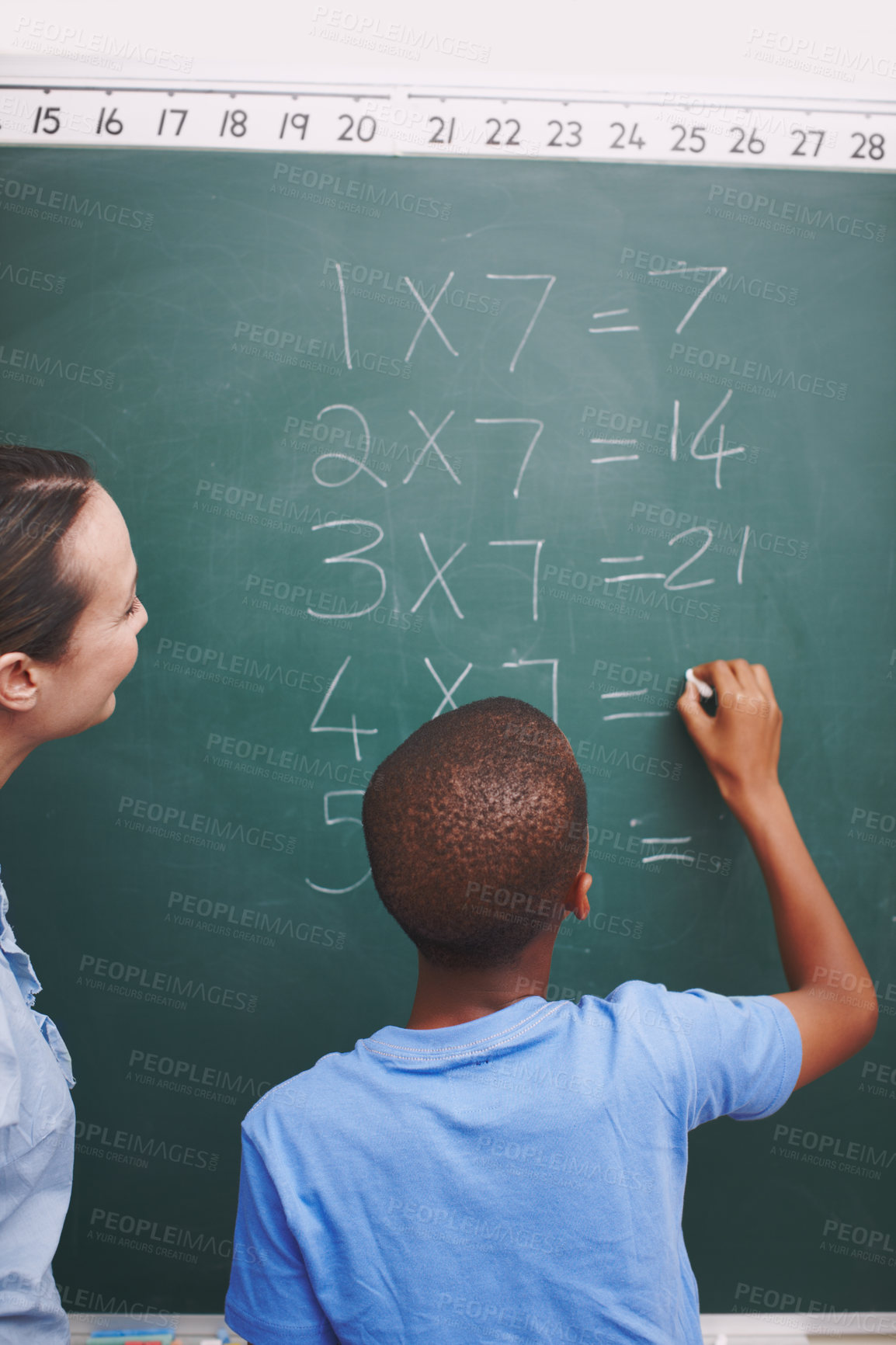 Buy stock photo Math, teacher and boy writing on chalkboard in classroom for solving number problem and answer question. Lesson, student back and solution for multiplication at school with scholarship and learning