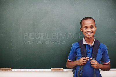 Buy stock photo An african american boy standing alongside copyspace at the blackboard