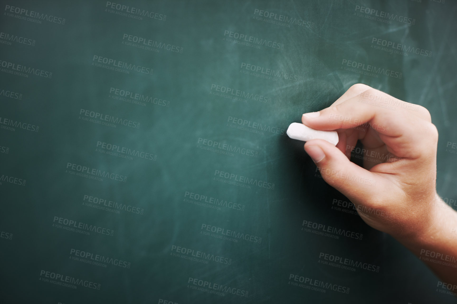 Buy stock photo Cropped image of a young boy's hand writing on a blackboard with a piece of chalk
