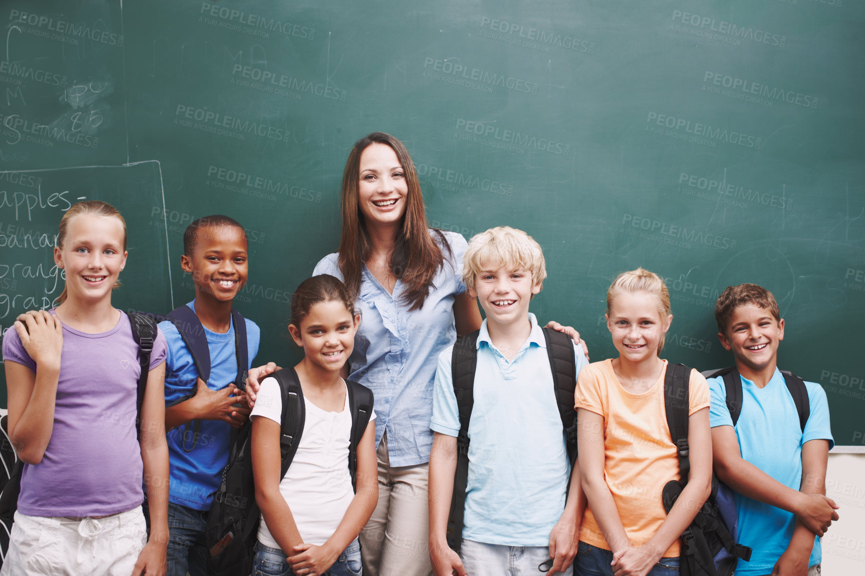 Buy stock photo Portrait, education and students with teacher, classroom and happy for learning, chalkboard and diversity. School, woman and kids in elementary, group and children with backpack, smile and studying