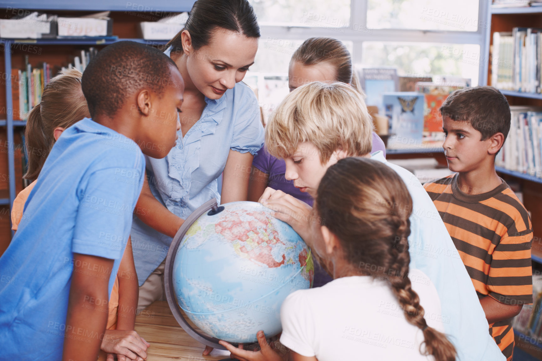 Buy stock photo Children, teacher and map with globe in library for geography education, planet learning and and science. Students, woman and global teaching with earth atlas for spatial discussion of climate change