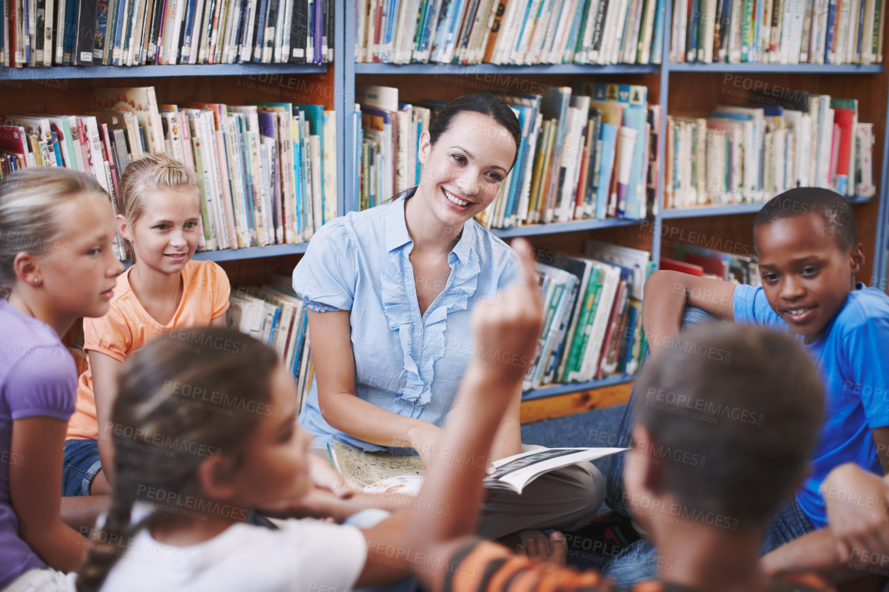 Buy stock photo Storytelling, teacher or student with questions in a classroom or library for learning development. Education, kids and children listening to woman with smile and conversation on fun books at school