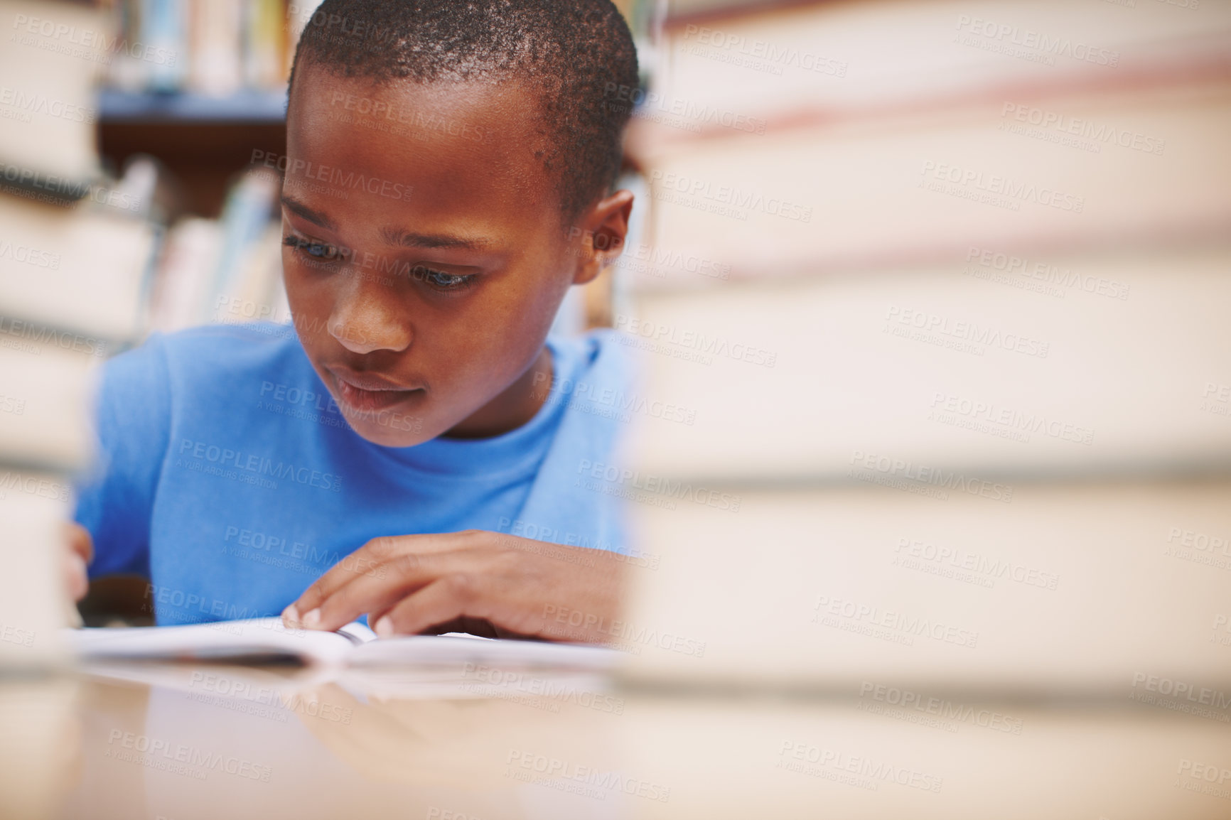 Buy stock photo Black child, writing and study in library for education, knowledge or academic opportunity at elementary school. Young boy, learning or books on table for lesson, growth and progress in assessment